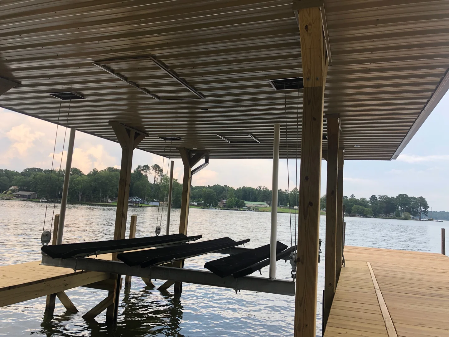 Boat-lift equipment beneath a covered dock