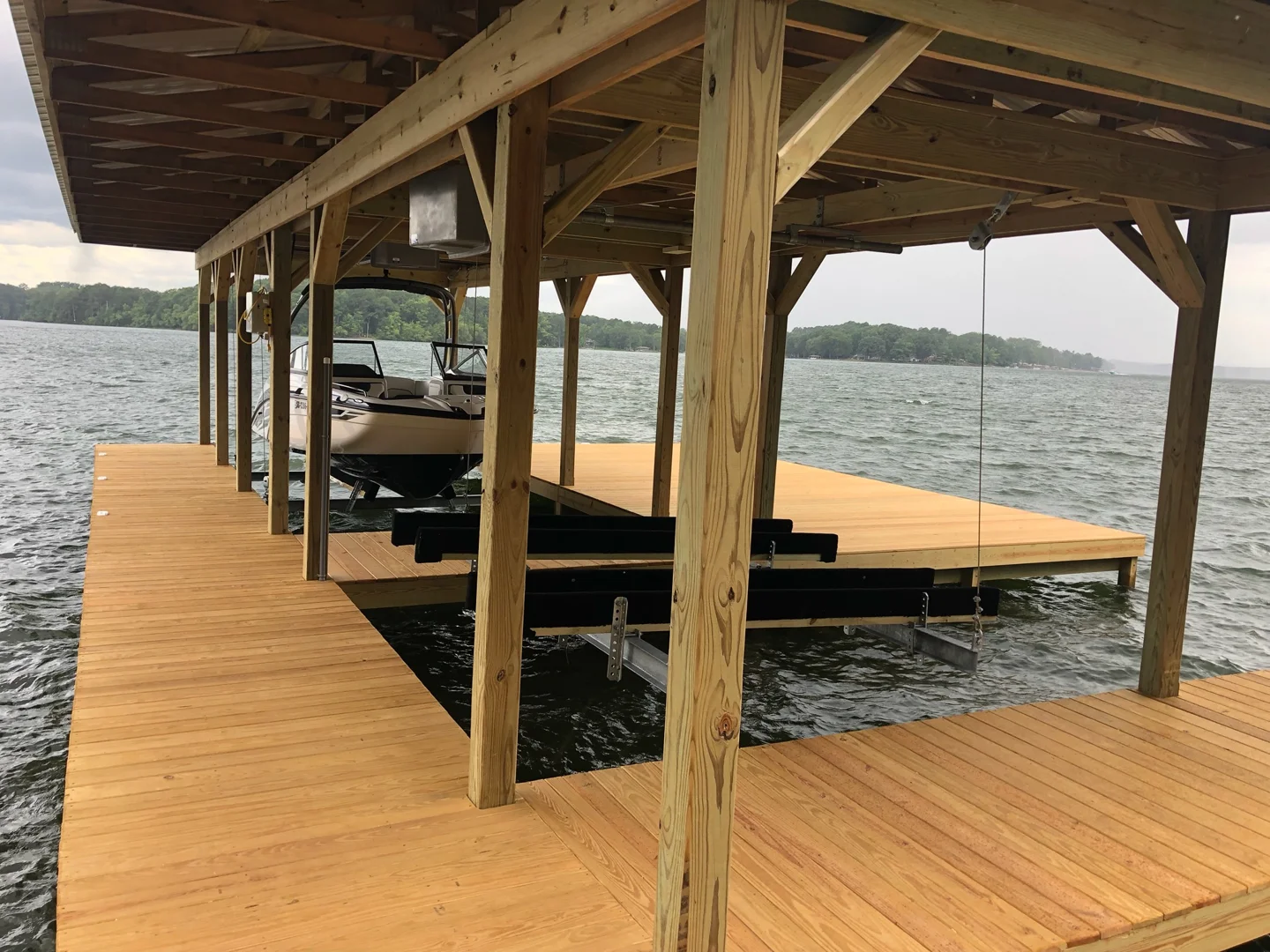 Timber framing and open deck space beside a boat slip